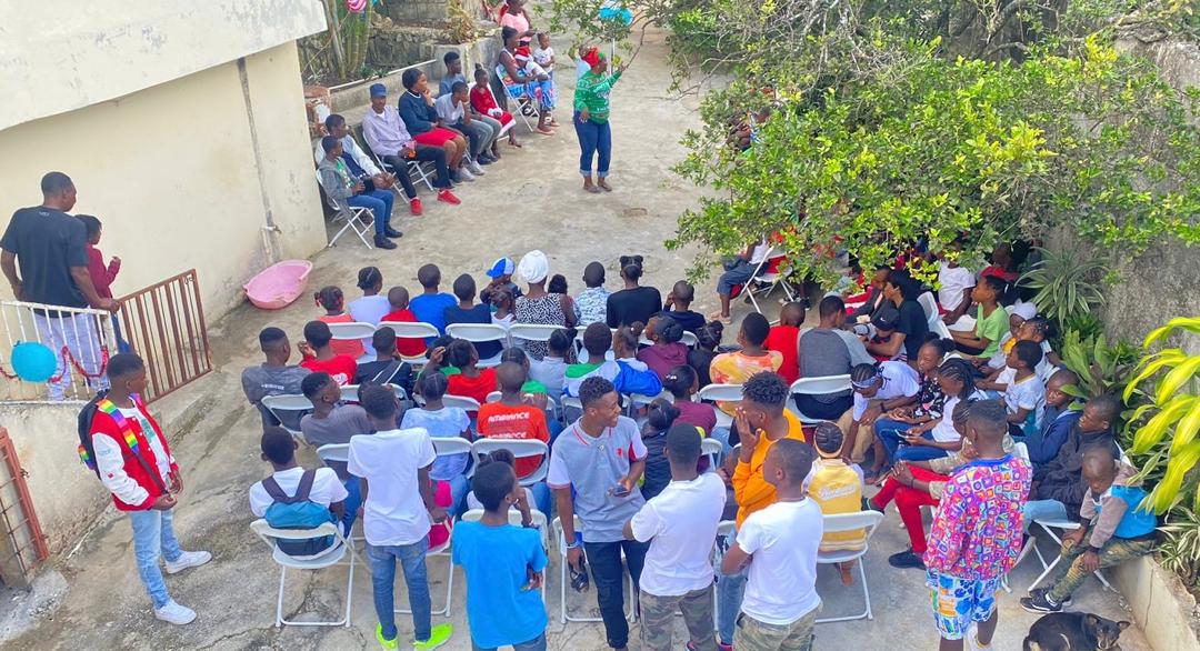 Photo of school children in Haiti with 2 instructors