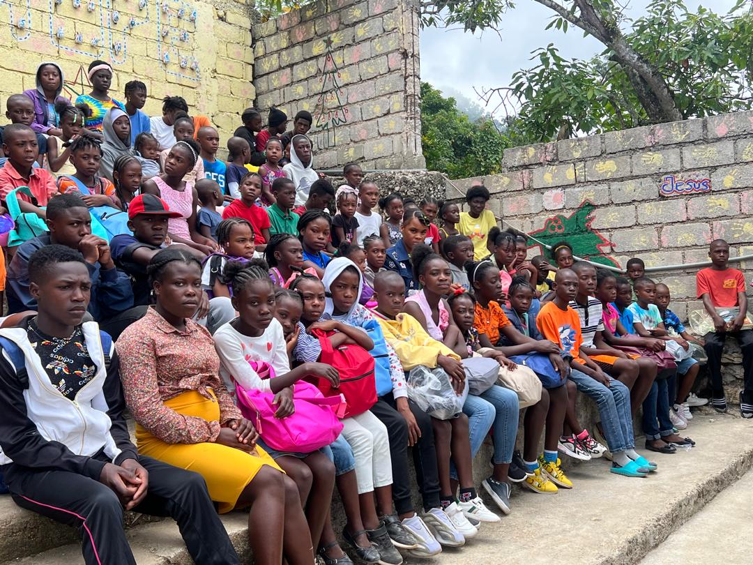 School kids in Haiti with two instructors